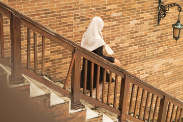 Muslim Contemplative Ascent in Outdoor Scene with Textured Elements