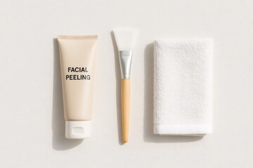 Naklejka premium Facial peeling cream tube, application brush, and clean towel providing a minimalist concept of skincare treatment