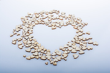 Wooden hearts form heaart shape on white background