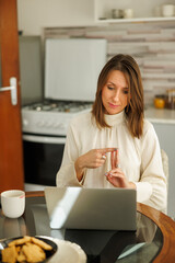 Business woman having online meeting using laptop computer while working from home