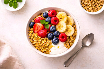 Healthy breakfast bowl with yogurt, granola and fresh berries on wooden table