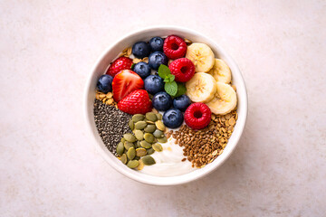 Healthy breakfast bowl with yogurt, granola and fresh berries on wooden table
