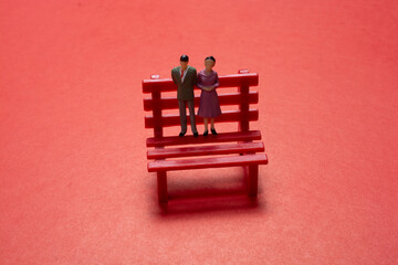 Statuette of people couple standing on bench