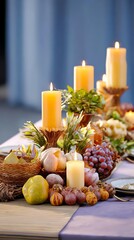 A beautifully arranged table featuring candles, fruits, and decorative elements, creating an inviting atmosphere for a gathering or celebration.