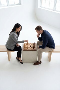 Strategic Minds: Professionals Engaged in a Chess Match