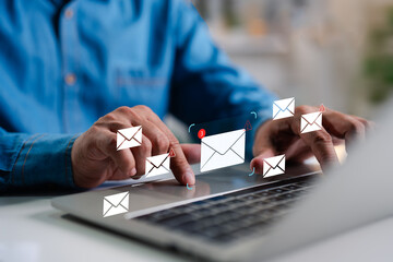 A Businessman working on a laptop open an email with triangle caution warning sign for notification error and maintenance concept, network security, computer virus detected, personal data protection.