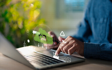 A Business professional using laptop computer for carbon footprint reduction, net zero emissions, showcasing eco-friendly technology, and sustainable energy data.
