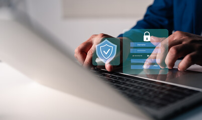 Hand of a man using mobile phone and laptop, secure access to user personal information, secure Internet access, information security encryption. Cybersecurity internet network data privacy concepts.