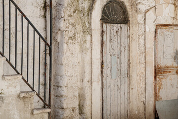 Old weathered doorway and stone wall in historic alley