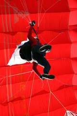 Colorful parachute at action sport meeting. Adrenaline, extreme sports meeting colorful parachute at blue sky