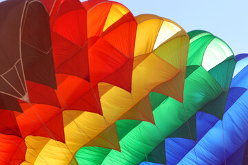 Colorful parachute at action sport meeting. Adrenaline, extreme sports meeting colorful parachute at blue sky