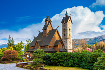 Medieval Norwegian stave wooden church Vang or Wang in summer and Snezka mountain in the background. Church was transferred from Vang in Norway to Karpacz in 1842. Karpacz, Poland
