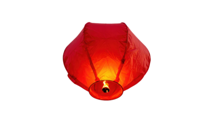 A vibrant red, paper-like object, aloft against a pure black backdrop. The central source of light emanates an orange glow