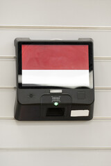Electronic self-service terminal with a touchscreen   mounted on an indoor wall.Concept of digital technology, automation, and user interaction.