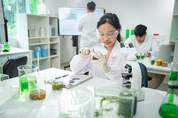 Scientist examining plant samples with magnifying glass in modern laboratory, focusing on plant biology, sustainability , environmental conservation, and innovative eco-friendly scientific solutions.