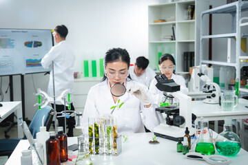 Research team analyzing plant samples in a modern laboratory, focusing on plant biology, sustainability science, environmental research, teamwork, and innovative eco-friendly for a sustainable future.