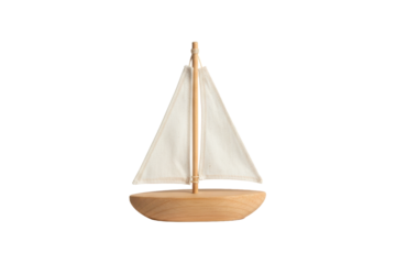Miniature wooden sailboat with a simple white sail and mast on a neutral surface