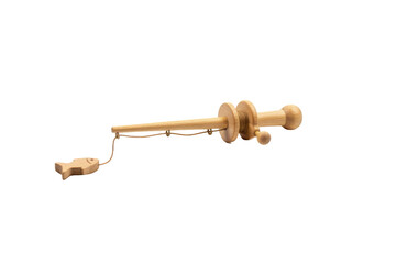 Minimalist wooden fishing rod with tiny fish symbol placed on the plain surface