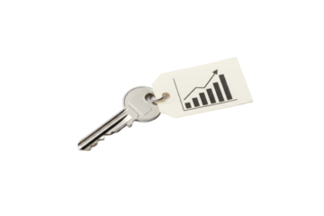 Silver key with a tag displaying a financial growth chart symbolizing success and opportunity