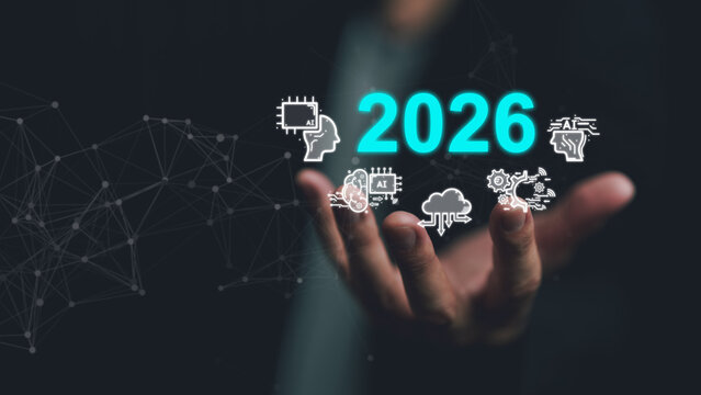 Human hand presenting 2026 with glowing AI icons and connected network line, symbolizing artificial intelligence, future technology trends, digital transformation, innovation, smart business vision. - Powered by Adobe