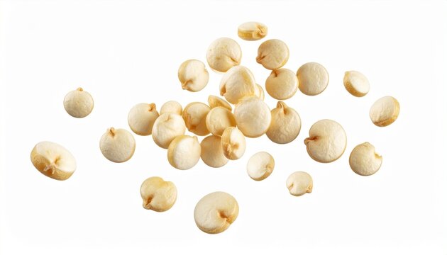 Scattered popped popcorn kernels on white background, fluffy and light with visible burst centers.