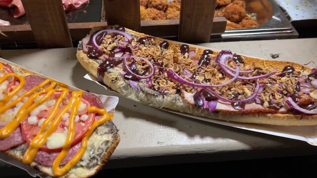 Polish zapiekanka at the Krakow Christmas market, Poland. A traditional Polish hot sandwich with cheese and filling. A variety of flavors.