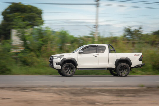 Nakhonsawan, Thailand - Oct, 2025: Toyota Hilux Revo pickup truck, A white car to speed running on the highway, on October 24, 2025, at Nakhon Sawan, Thailand.