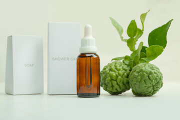 brown glass dropper bottles of natural herbal essential oil from Kaffir lime for soap skin care - beauty product on a white background