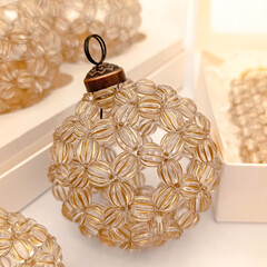 Elegant handmade Christmas ball made brown transparent beads with gift box. Close up and blurred background