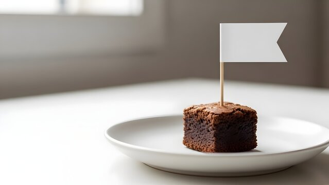 Chocolate Brownie with Blank Flag on White Plate Symbolizing Celebration, Dessert, Food Industry, Baking, Cuisine