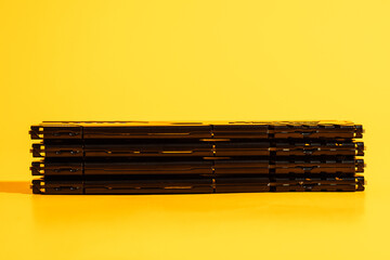 Long horizontal stack of black RAM modules on yellow background. High quality photo