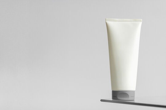 Tube de cr&egrave;me blanc sur un fond blanc - mise en sc&egrave;ne esth&eacute;tique pour produit de beaut&eacute;