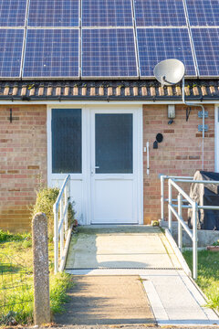 Ramp and handrails leading up to door of house to make access easier
