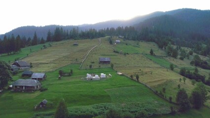 Green grass hill and sunset over mountain