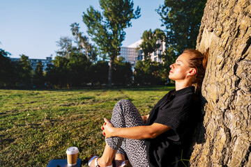 Mindful pause outdoors with urban woman in city park.