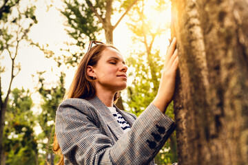 Urban woman experiencing mindful connection with nature in city park © Barillo Images