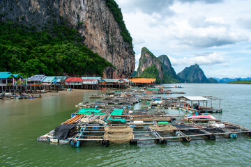 Koh Panyi floating Muslim village in Thailand. Boats and limestone rock formations on Andaman Sea, Phi Phi islands 