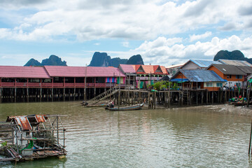 Koh Panyi floating Muslim village in Thailand. Boats and limestone rock formations on Andaman Sea, Phi Phi islands 
