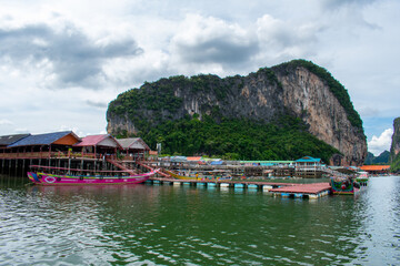 Koh Panyi floating Muslim village in Thailand. Boats and limestone rock formations on Andaman Sea, Phi Phi islands 