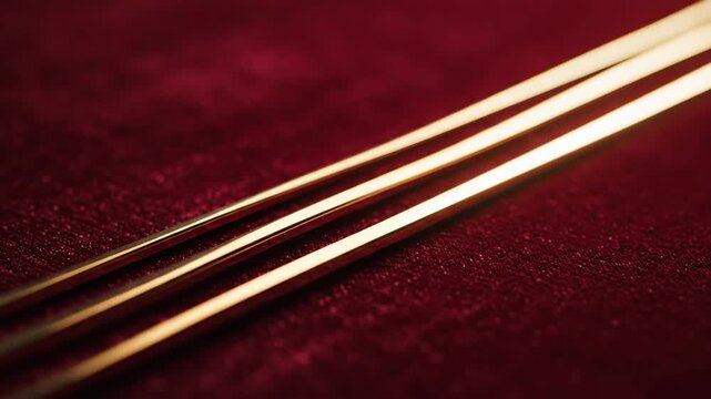 Three parallel golden lines on a deep red background