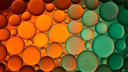 Glowing orange and green cells of oil, captured in tight abstraction. Soft light defines their sleek, gradient-rich surfaces.
