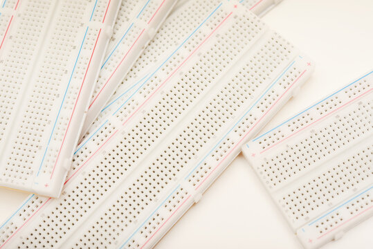 A solderless board for electronics. A breadboard for experiments in electronics.