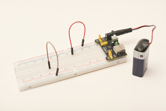 A solderless board for electronics with a battery. A breadboard for experiments in electronics.