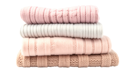 Stacked, folded soft knit sweaters in pastel pinks, whites, and beige colors