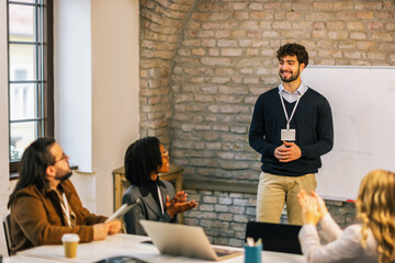 Young professional presenting strategy to team at conference