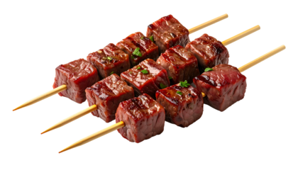 Three skewers of grilled, cubed beef, lightly seasoned and garnished