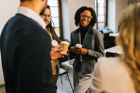 Business team enjoying coffee break in office - Powered by Adobe