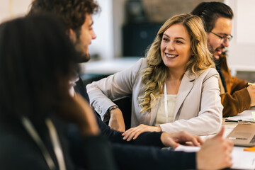 Young multicultural business team collaborating at laptop