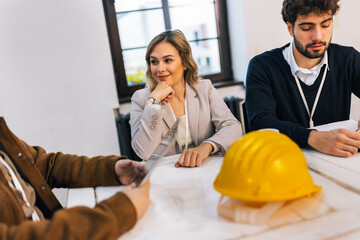 Group of young construction engineers planning in conference room