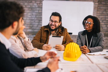 Group of young construction engineers planning in conference room